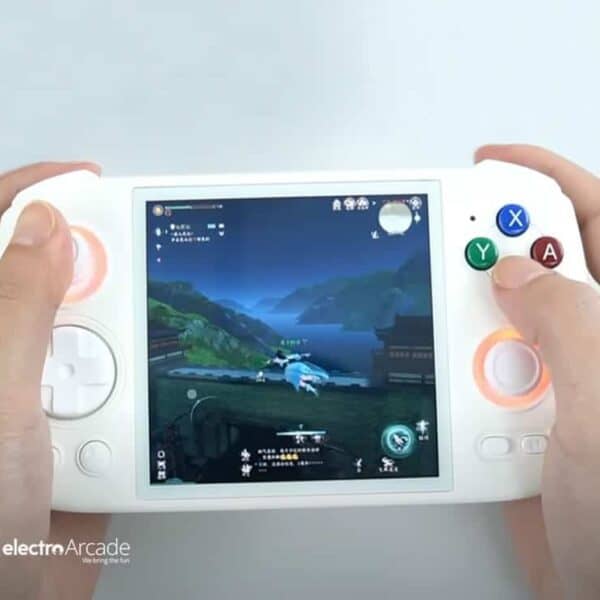 Handheld gaming console with colorful buttons and a screen displaying a game scene.