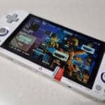 Handheld gaming console displaying Crossmix OS setup with custom upgrade card.